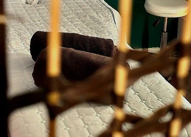 Relaxing massage bed at Healing Touch, Belfast, Northern Ireland featuring cozy brown towels and soothing ambiance.