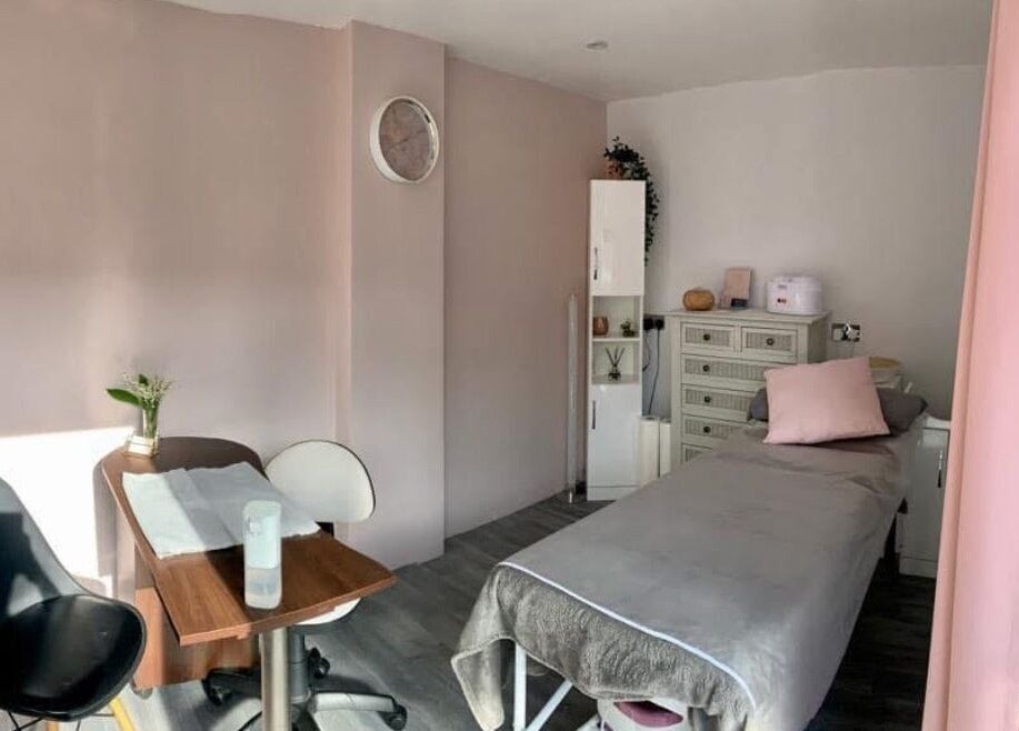 Serene treatment room at Lorna Dorrington Beauty, Fordingbridge, England, GB with pastel decor and cozy bed.
