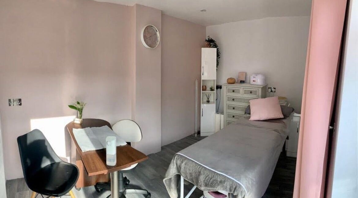 Serene treatment room at Lorna Dorrington Beauty, Fordingbridge, England, GB with pastel decor and cozy bed.
