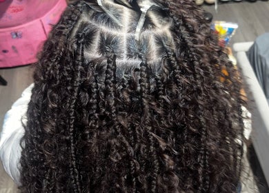 Detailed braided hairstyle seen from above at triptoogoated in Woodbridge Township, New Jersey, US.