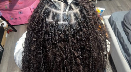 Detailed braided hairstyle seen from above at triptoogoated in Woodbridge Township, New Jersey, US.