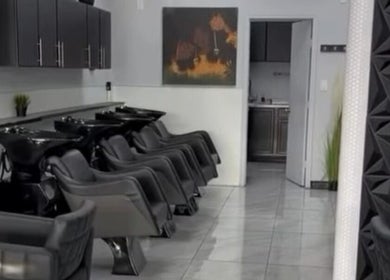 Modern salon chairs and wash stations at Jk Braiding Spot, Arlington, Texas, US, showcasing sleek interior design.