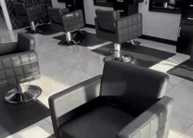 Modern salon chairs at Jk Braiding Spot in Arlington, Texas, US, showcasing a sleek and professional setup.