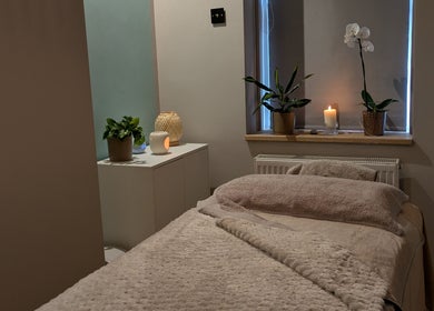Peaceful spa room at Azure Wellness, Combe Martin, England, GB, featuring cozy bed and calming decor.