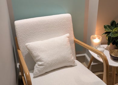 Comfortable chair with candle at Azure Wellness, Combe Martin, England, GB for a serene retreat.