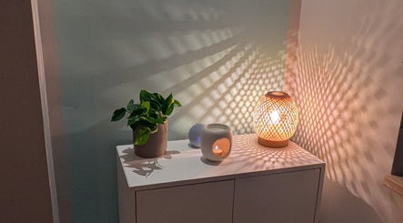 A calming setup with a plant and lamp casting patterns in Azure Wellness, Combe Martin, England, GB.
