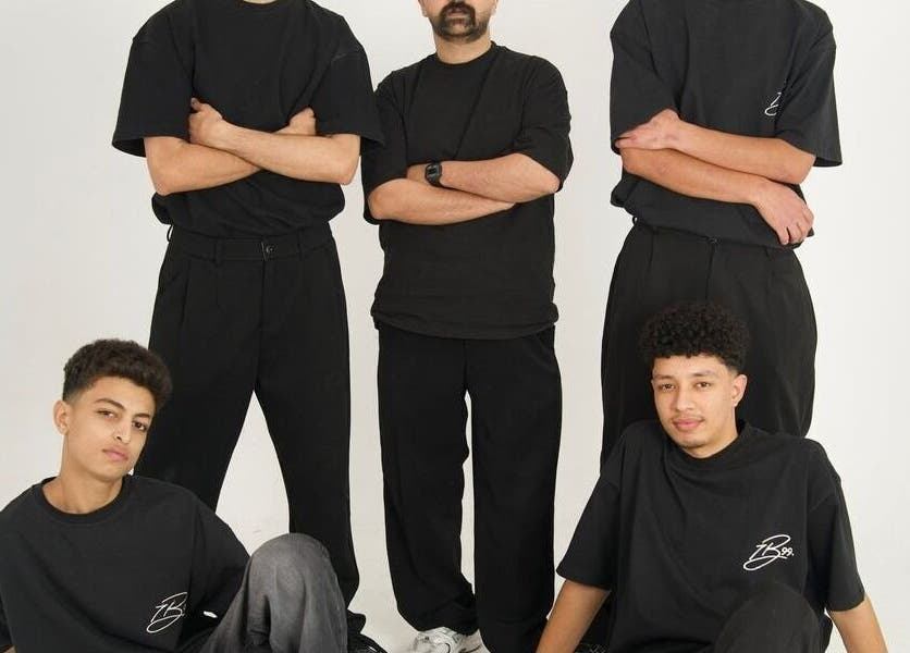 Group of five individuals in black outfits at HANOSA, Ismailia Governorate, Ismailia Governorate, EG.