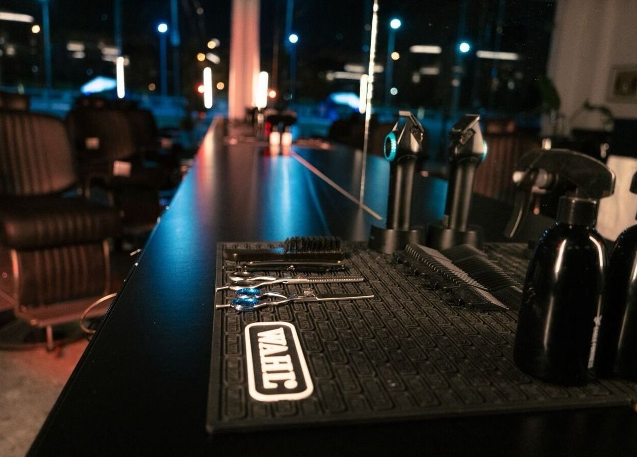 Barber tools on a sleek counter at HANOSA, Ismailia Governorate, EG, showcasing luxury grooming services.