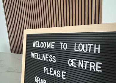 Welcome sign at Sanctuary wellness center, Louth, England, GB with inviting wooden background.