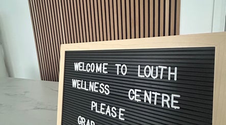Welcome sign at Sanctuary wellness center, Louth, England, GB with inviting wooden background.