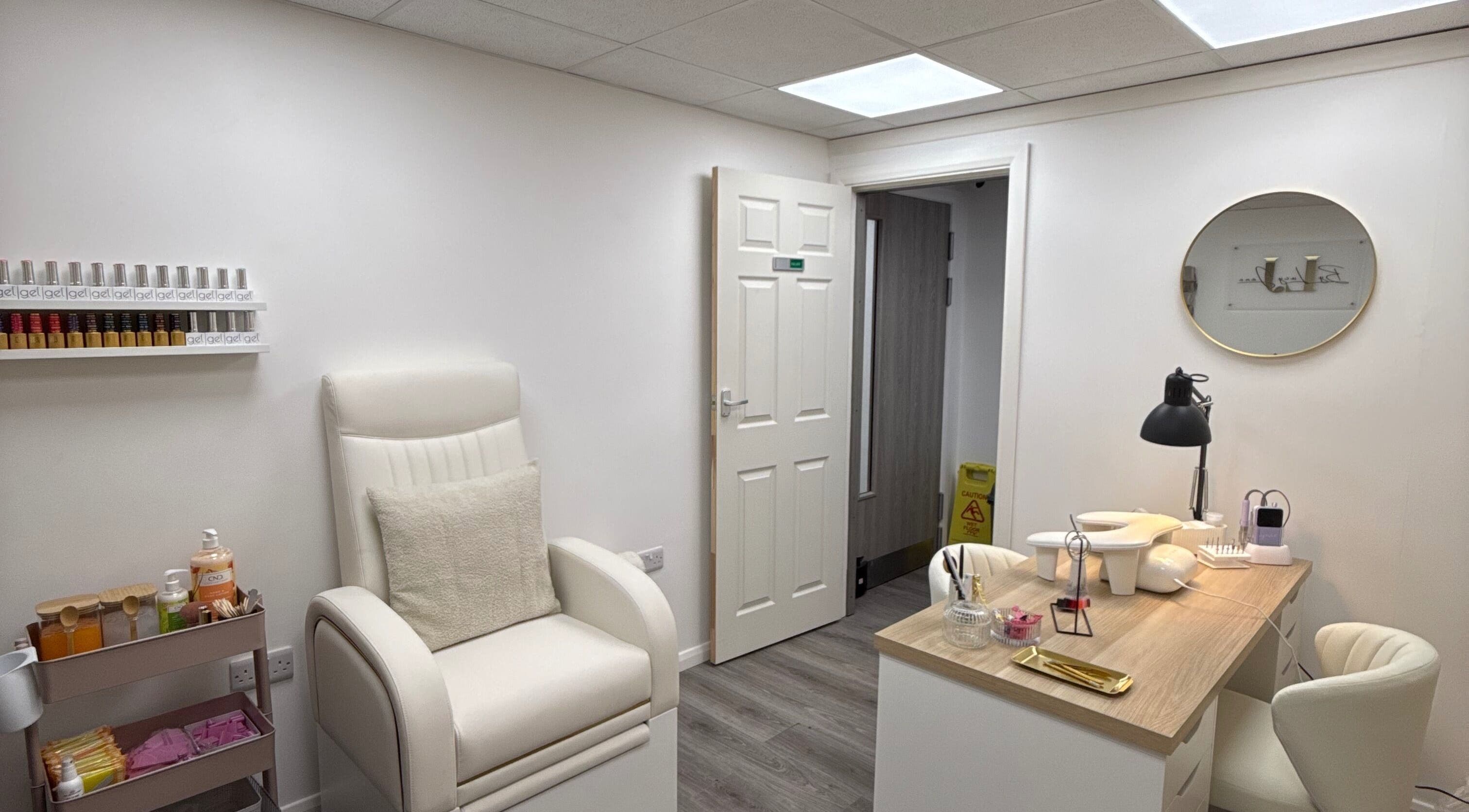 Chic nail salon interior at By Lucy Jane in Bognor Regis, England, GB with cozy seating and organized workstations.