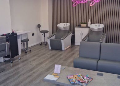 Modern salon interior at By Lucy Jane, Bognor Regis, England, GB with stylish chairs and washing stations.