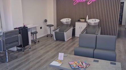 Modern salon interior at By Lucy Jane, Bognor Regis, England, GB with stylish chairs and washing stations.