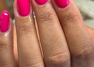 Vibrant pink manicure by By Lucy Jane in Bognor Regis, England, GB, showcasing sleek, polished nails.