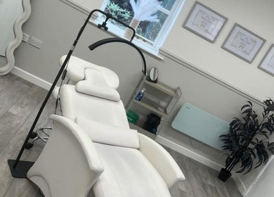 Elegant treatment room at Sculpt & Pout SPMU, Congleton, England, GB, featuring cozy white chair and decor.