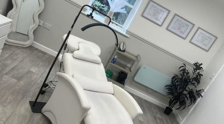 Elegant treatment room at Sculpt & Pout SPMU, Congleton, England, GB, featuring cozy white chair and decor.