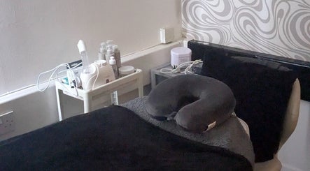 Relaxing treatment room at F.A.B by Louise, Cambuslang, Scotland, GB, featuring massage bed and skincare tools.