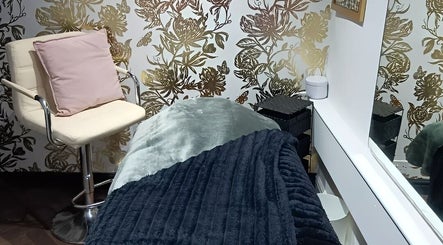 Elegant treatment room at F.A.B by Louise in Cambuslang, Scotland, GB with floral decor and a plush chair.