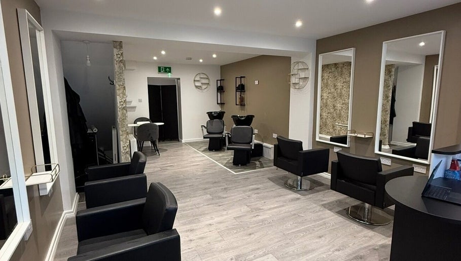 Modern salon interior at SPACE, Radcliffe, England, GB, featuring sleek chairs and mirrors.