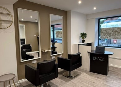 Sleek beauty salon interior at SPACE in Radcliffe, England, GB with modern chairs, mirrors, and decor.