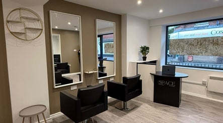 Sleek beauty salon interior at SPACE in Radcliffe, England, GB with modern chairs, mirrors, and decor.