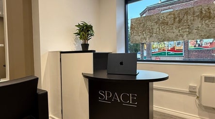 Modern reception at SPACE, Radcliffe, England, GB, featuring sleek desk and potted plant.