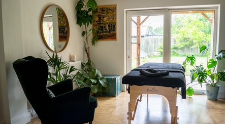 Peaceful massage room at Quiet Meadow Massage & Holistic Therapies, Spaldington, England, GB, with lush greenery.
