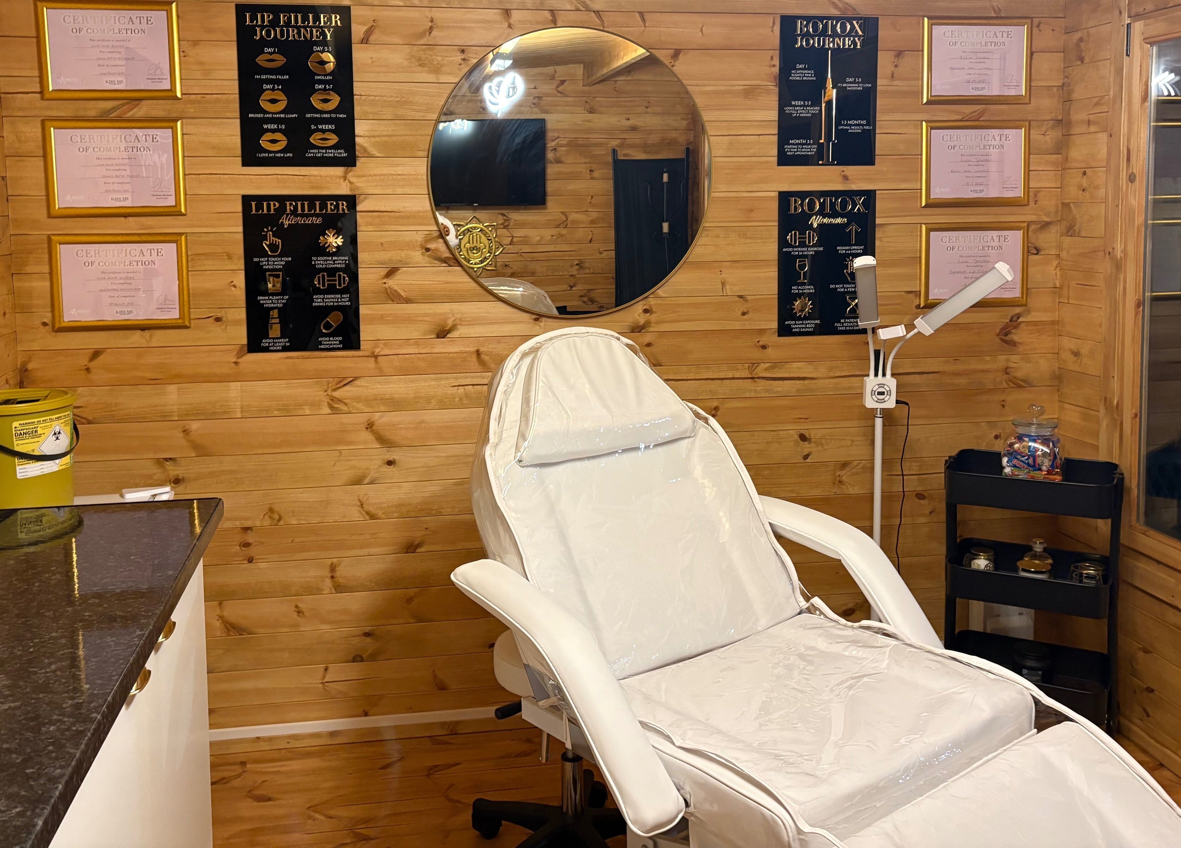 Relaxing treatment room at Cabin Cosmetics, Verwood, England, GB with chair and wooden interior decor.