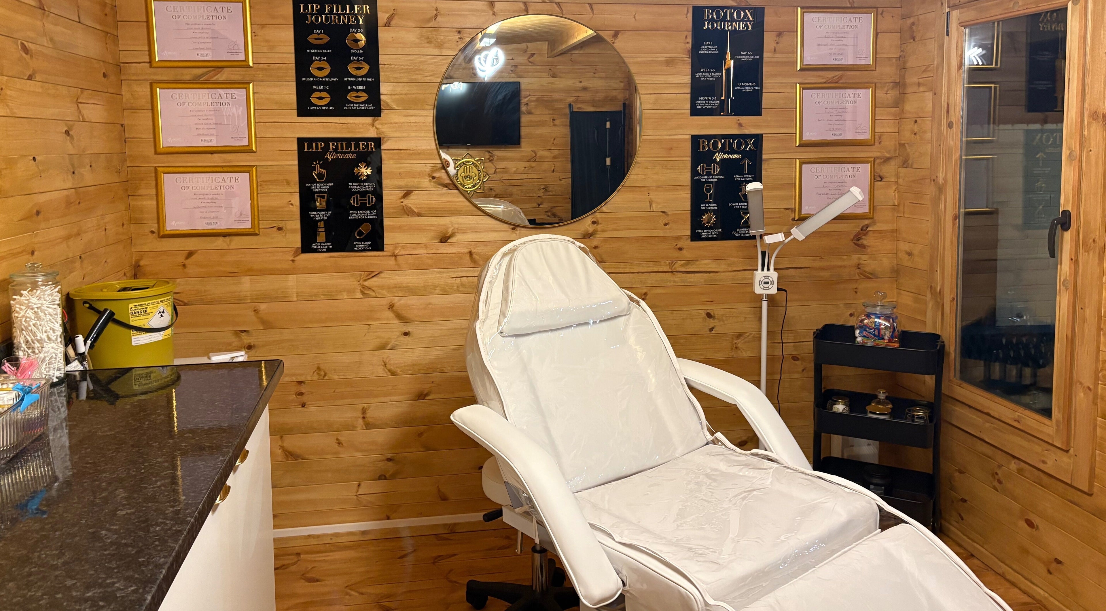 Relaxing treatment room at Cabin Cosmetics, Verwood, England, GB with chair and wooden interior decor.