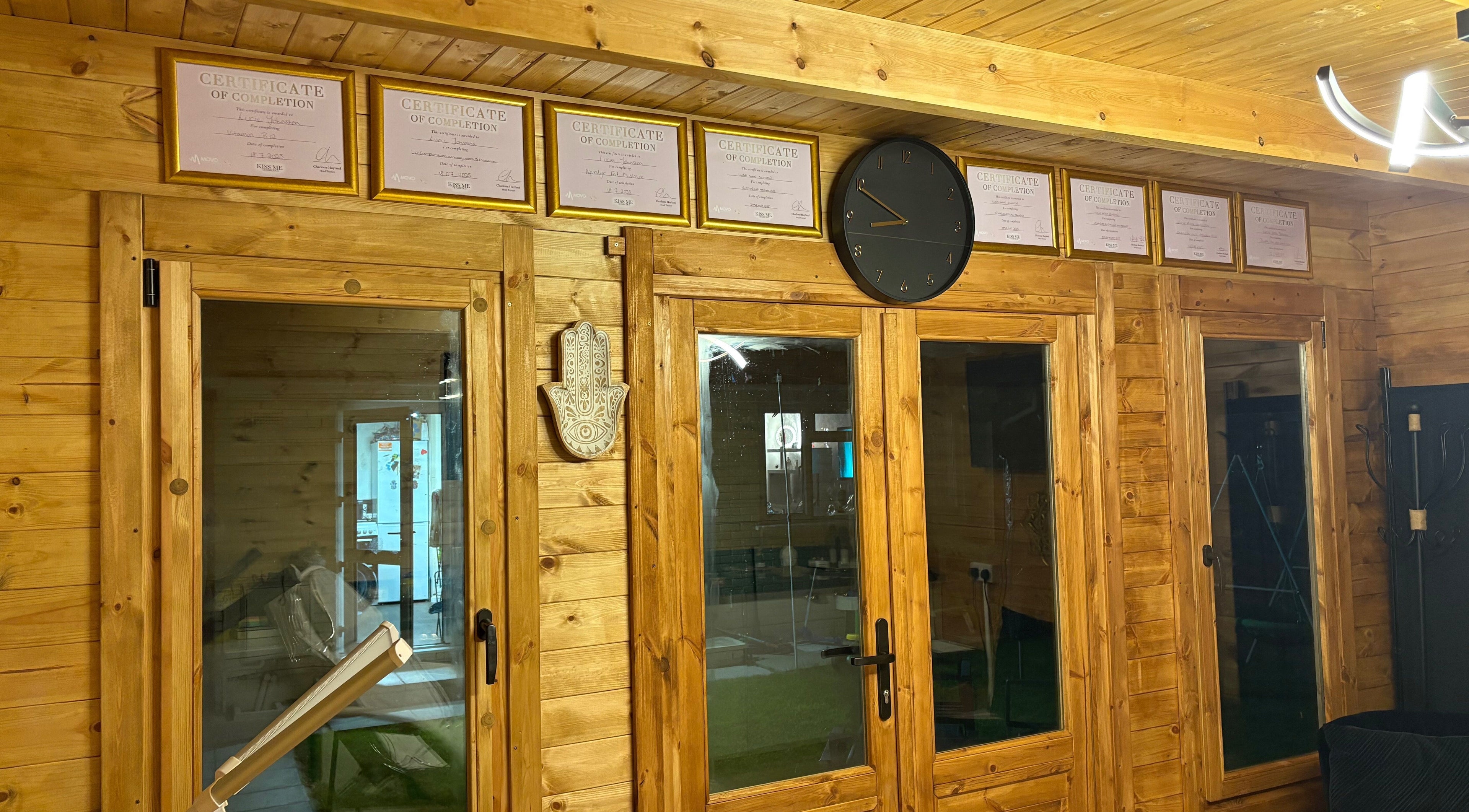 Cabin Cosmetics in Verwood, England, GB features wooden interior with certificates and decor on display.