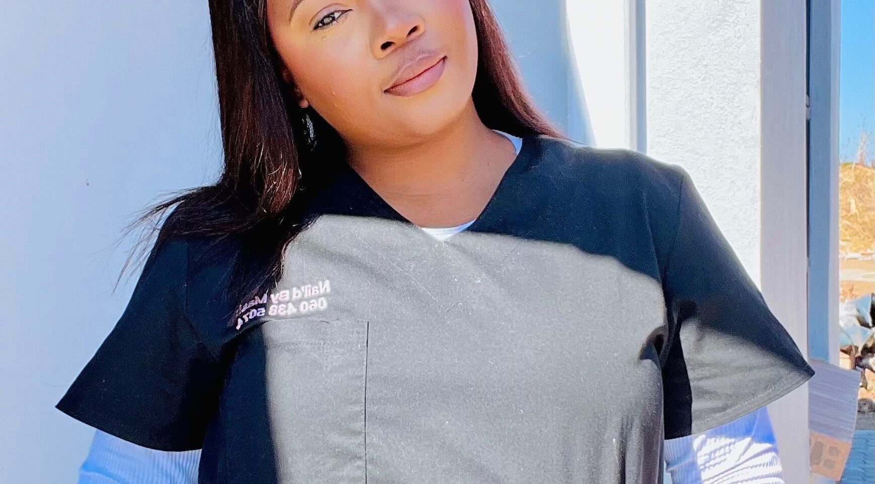 Nail’d By Mash staff member greets with a smile at Emalahleni, Mpumalanga, ZA.