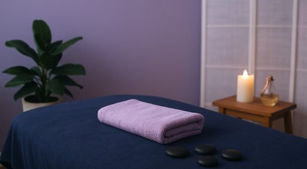 Peaceful massage area at 416 Skin Aesthetics & Academy, Toronto, Ontario, CA with soft candlelight and stones.