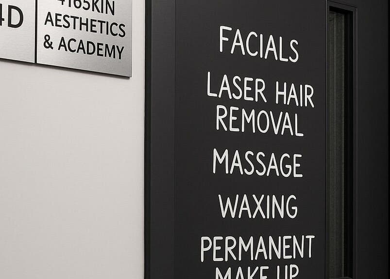 Door signage of 416 Skin Aesthetics & Academy, Toronto, Ontario, CA, detailing services like facials and massages.