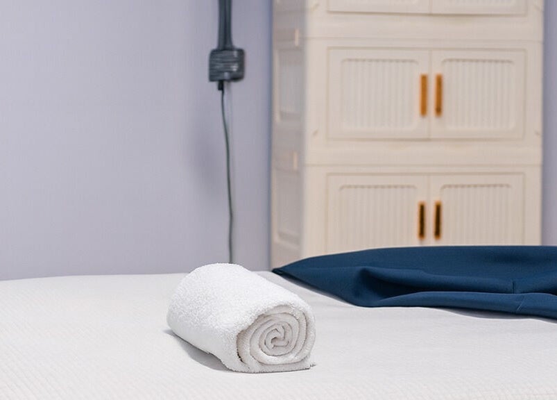 Relaxing treatment table at 416 Skin Aesthetics & Academy in Toronto, Ontario, CA with a rolled towel.