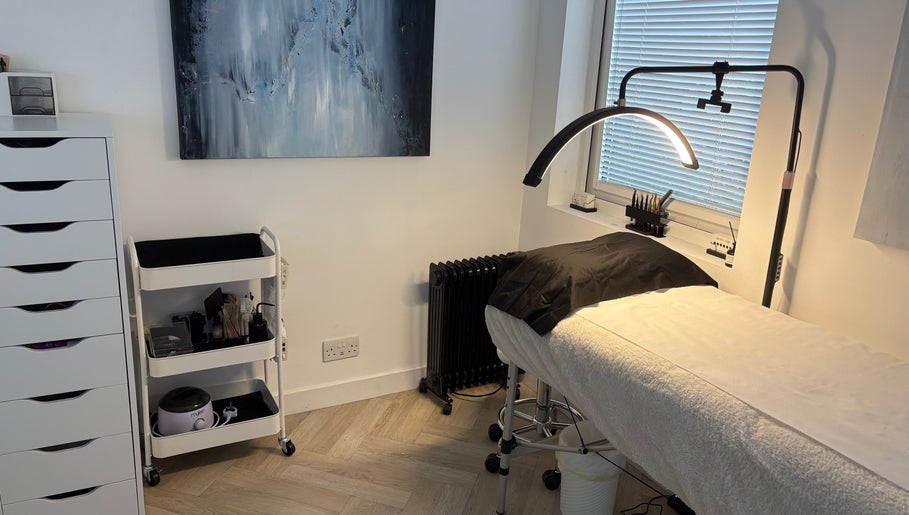 Modern lash treatment room at Divinely Lashed, Glasgow, Scotland, GB with sleek furnishings and soft lighting.