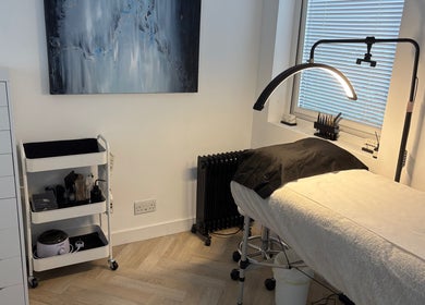 Modern lash treatment room at Divinely Lashed, Glasgow, Scotland, GB with sleek furnishings and soft lighting.