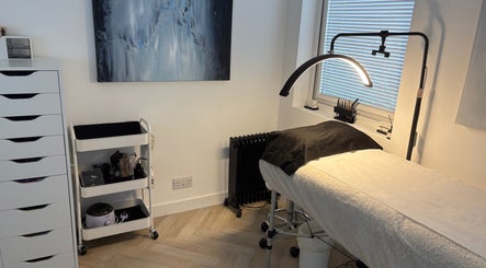 Modern lash treatment room at Divinely Lashed, Glasgow, Scotland, GB with sleek furnishings and soft lighting.