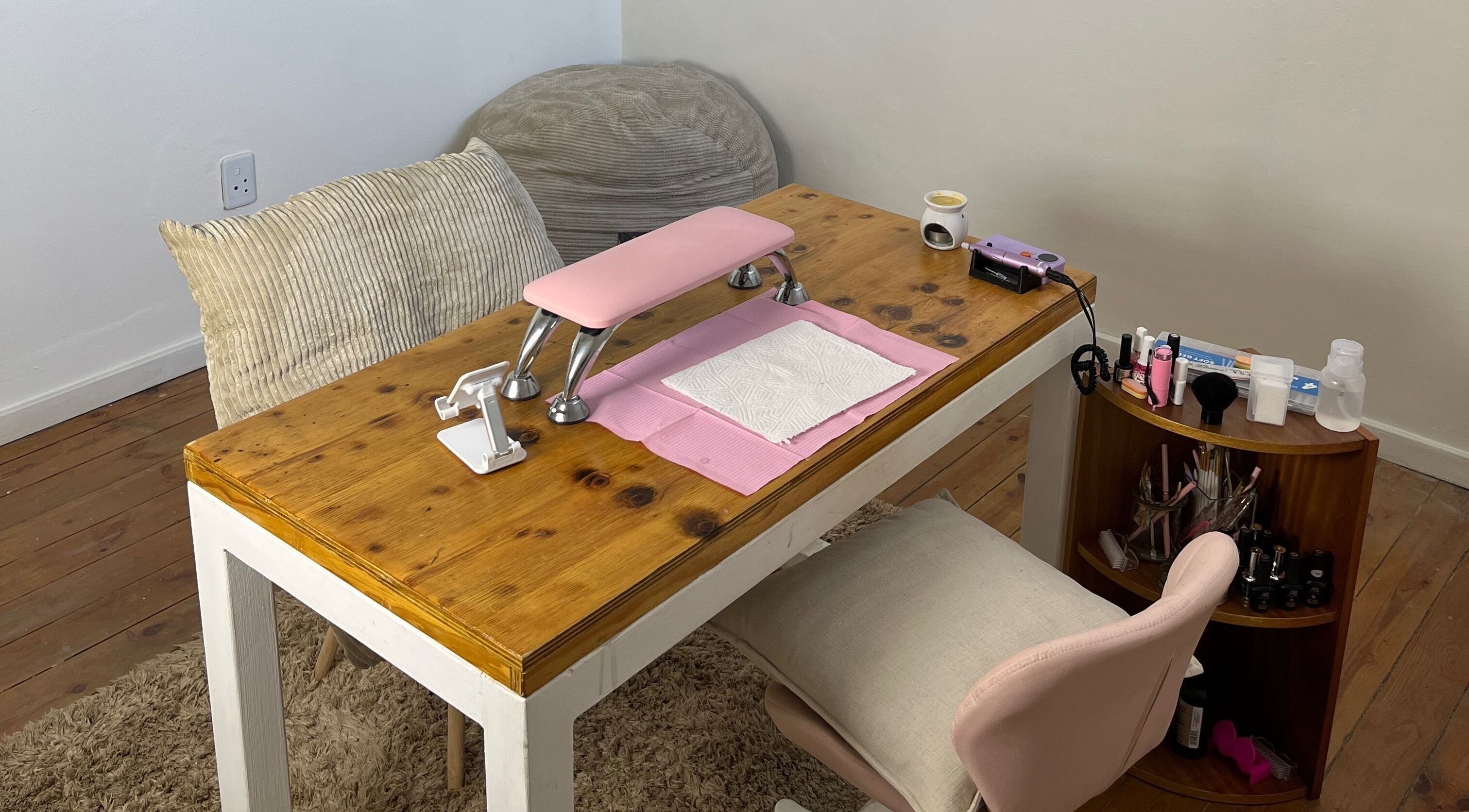 Chic nail station at Saintysclaws, Randburg, Gauteng, ZA, showcasing a neat setup with a pink armrest.