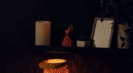 Cozy corner with lit lamp at Feel Good Massage Studio, Warszawa, Województwo Mazowieckie, PL.