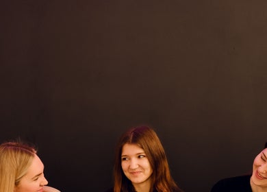 Three women sharing smiles at Feel Good Massage Studio in Warszawa, Województwo Mazowieckie, PL.