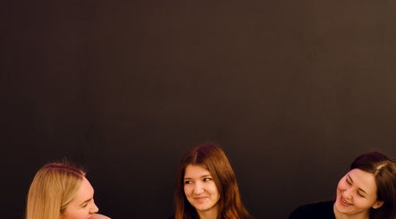 Three women sharing smiles at Feel Good Massage Studio in Warszawa, Województwo Mazowieckie, PL.