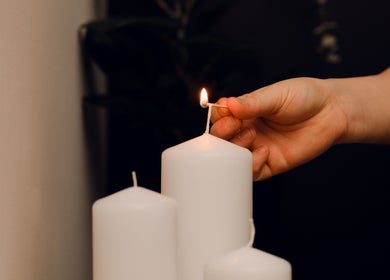 Candle being lit by hand at Feel Good Massage Studio, Warszawa, Województwo Mazowieckie, PL.