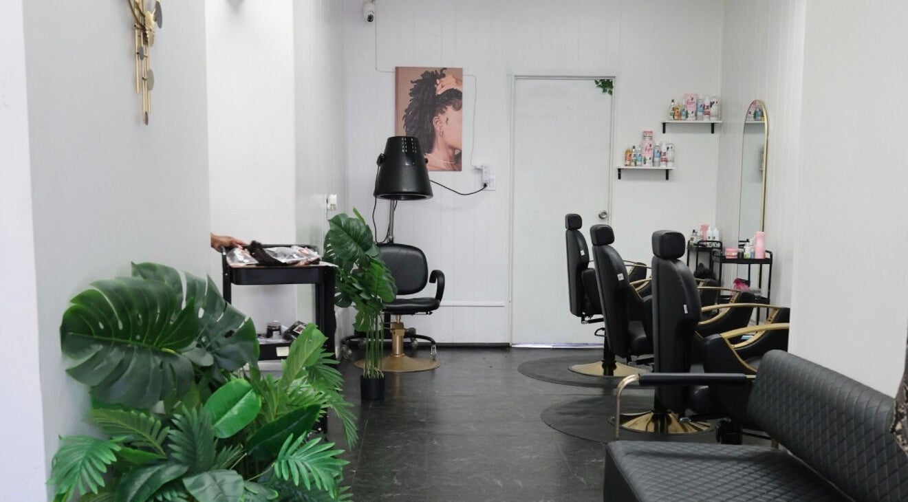 Modern interior of Natty By Nayee Corp (Loctician) at Floral Park, NY, US with stylish chairs and decor.