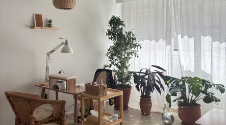 Bright nail station at Ordo Beauty Salon, Rabat, Rabat-salé-kénitra, MA with wicker chair and green plants.