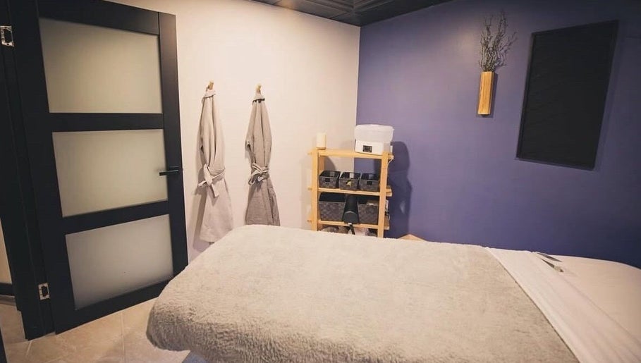 Tranquil spa room at T&S Paradise Touch Spa, San Jose, California, US, featuring cozy robes and massage bed.