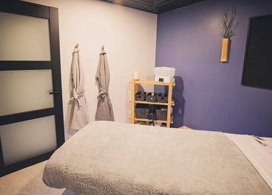 Tranquil spa room at T&S Paradise Touch Spa, San Jose, California, US, featuring cozy robes and massage bed.