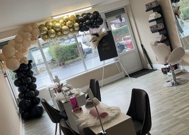 Elegant interior of Enchantedbykait in Farnworth, England, showcasing beauty stations and decor.