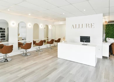 Stylish interior of Allure Hair and Beauty Co in Mitchelton, Queensland, AU, showcasing modern seating and decor.