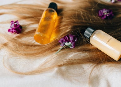Hair products on blonde locks with purple flowers at Allure Hair and Beauty Co, Mitchelton, Queensland, AU.