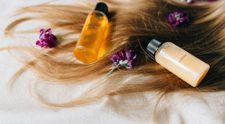 Hair products on blonde locks with purple flowers at Allure Hair and Beauty Co, Mitchelton, Queensland, AU.